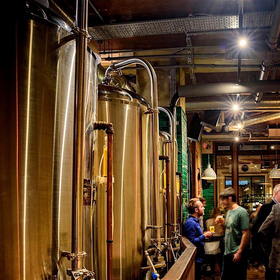 Internal brewing tanks full of beer at the Long Arm pub