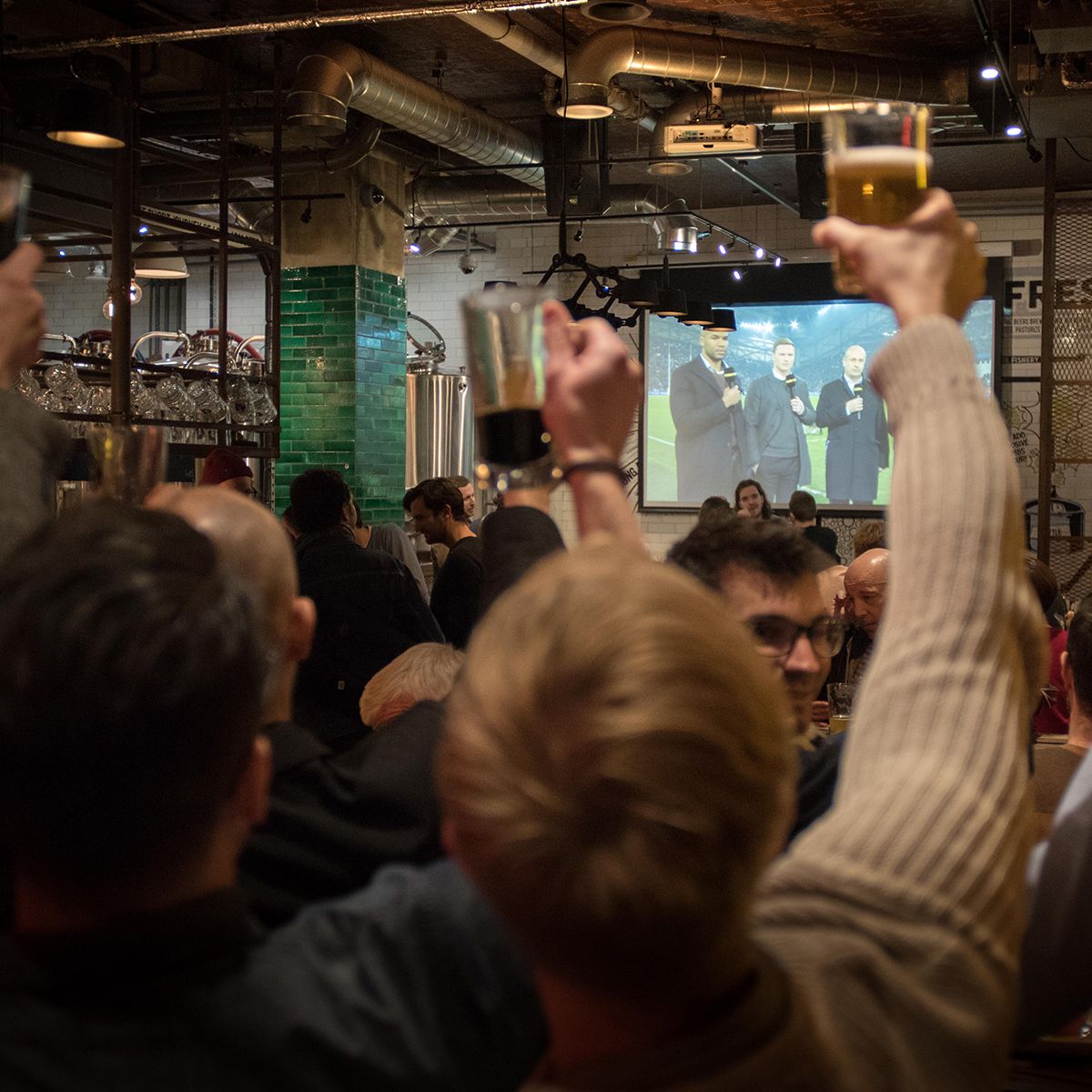 Crowds watching live sport at the Long Arm pub near Liverpool Street Station, east London