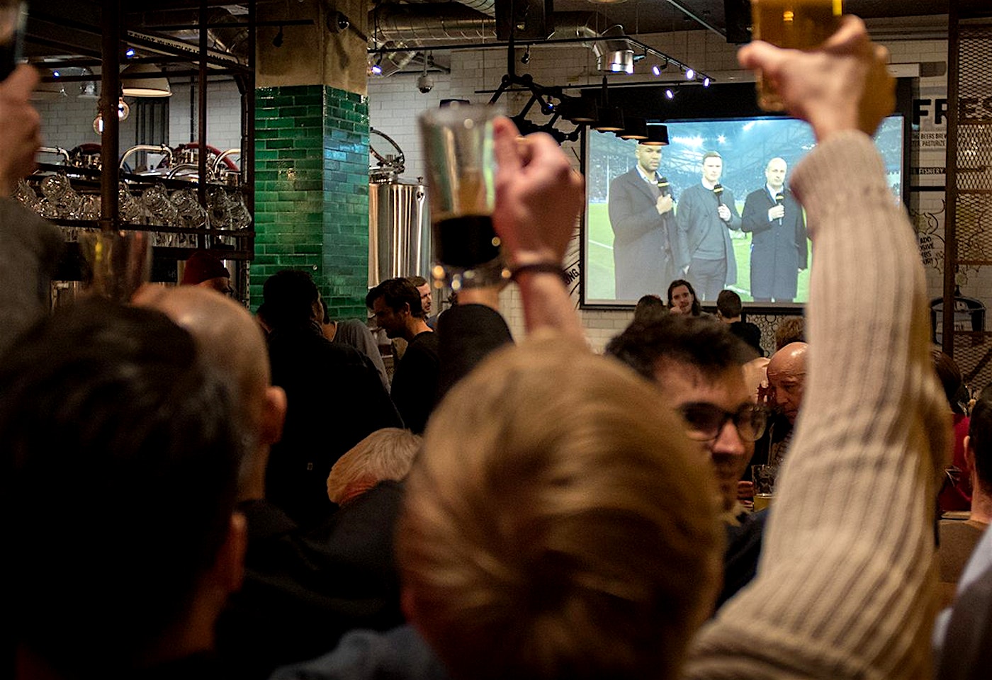 Crowds watching live sport at the Long Arm pub near Liverpool Street Station, east London