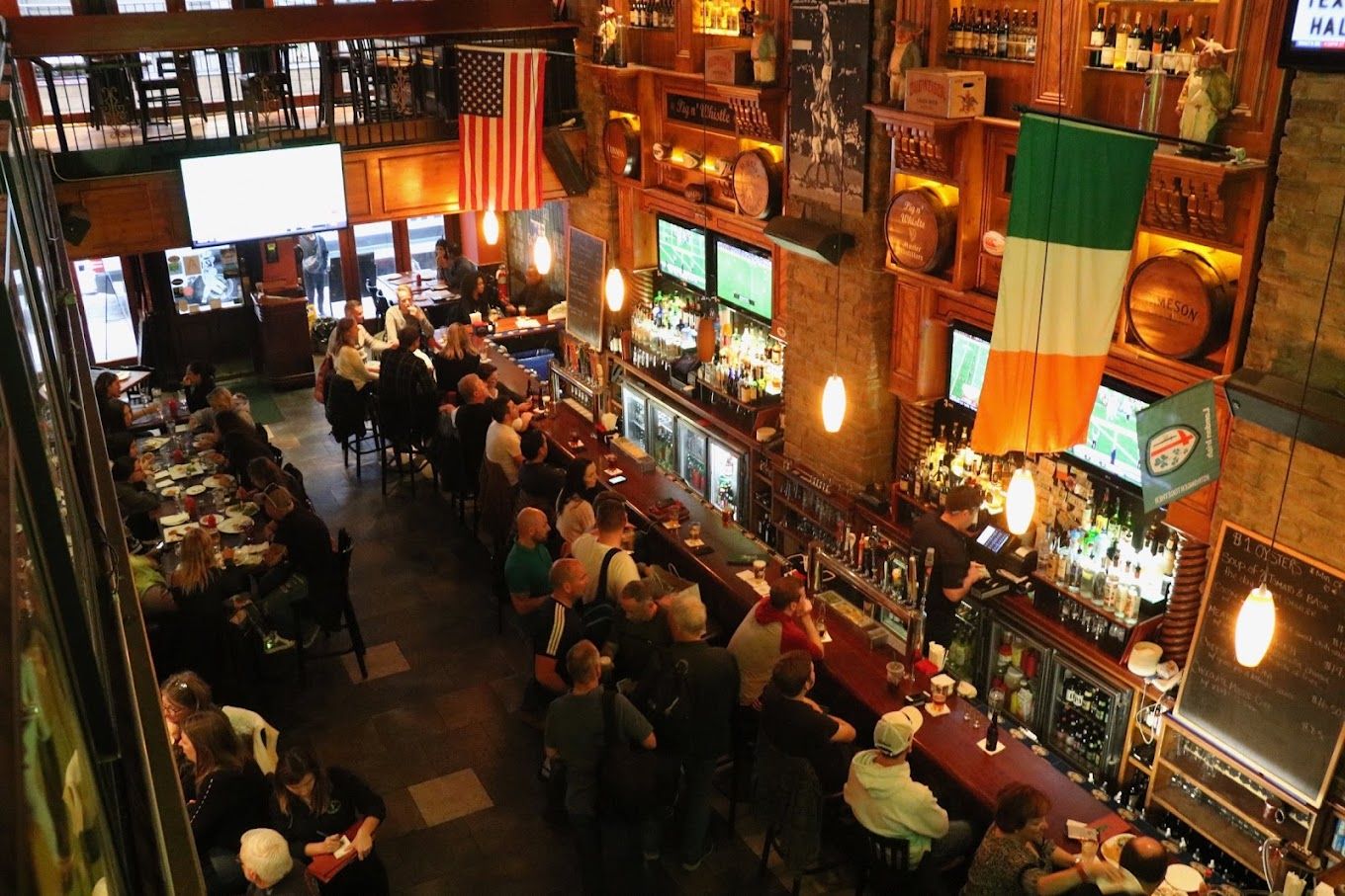 People watching sports at Pig n' Whistle, a sports bar in NYC. 