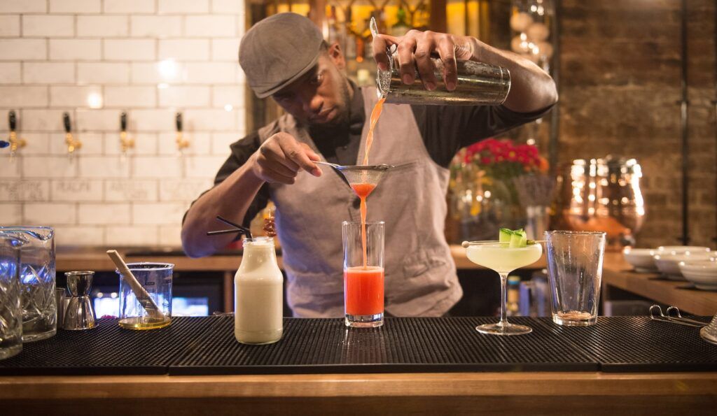 A bartender mixing drinks at Dirty Dicks, a pub near Liverpool Street