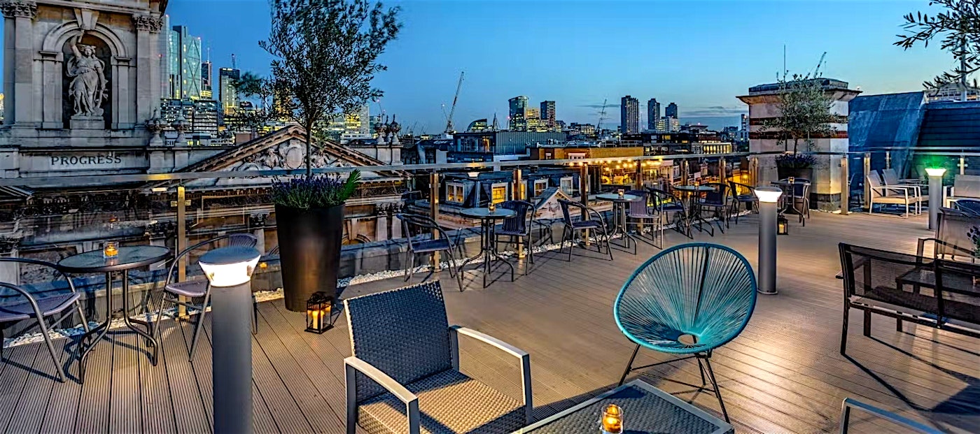Blue hour at the Courthouse Hotel, sunset over the London skyline as seen from the roof terrace