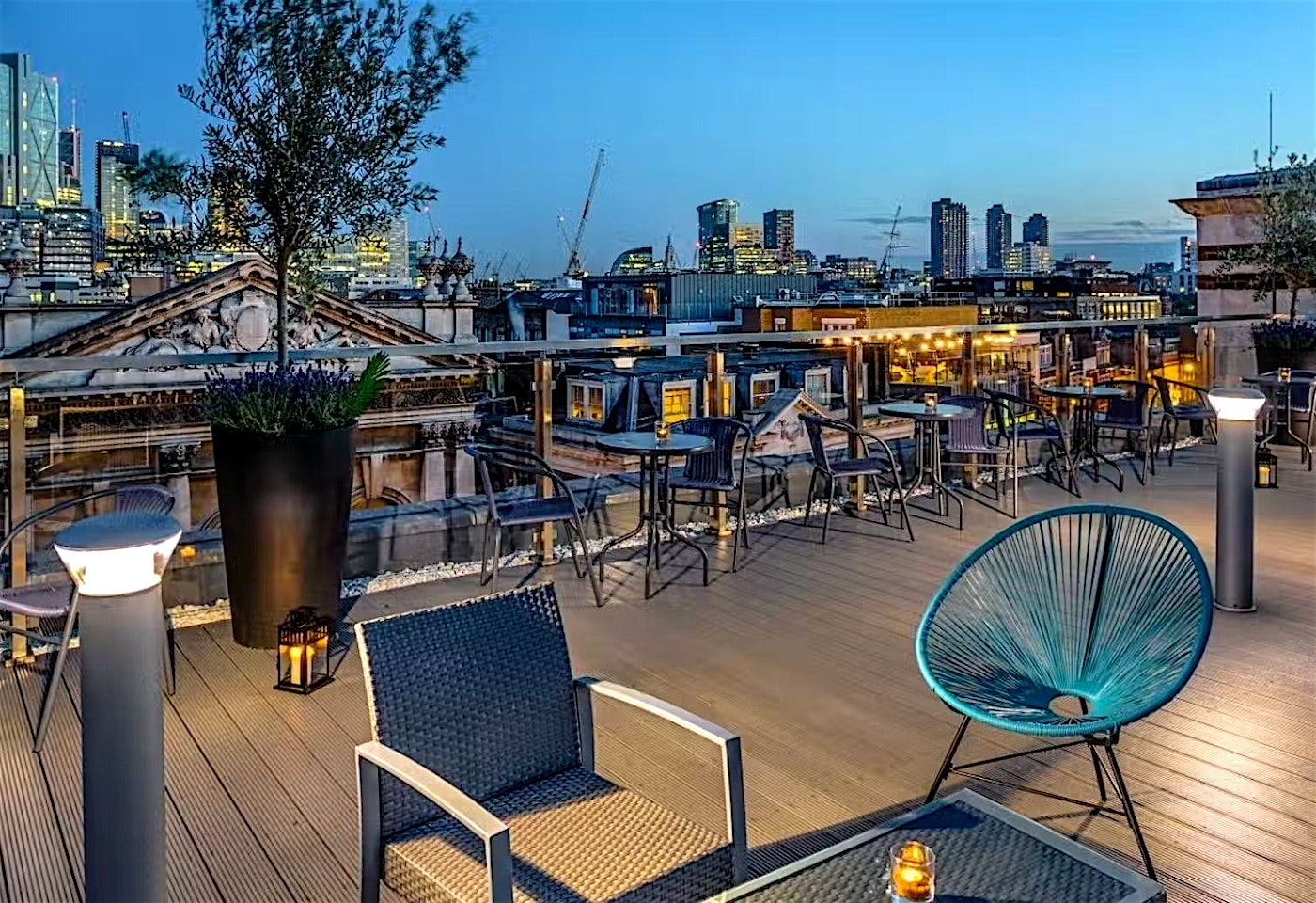 Blue hour at the Courthouse Hotel, sunset over the London skyline as seen from the roof terrace