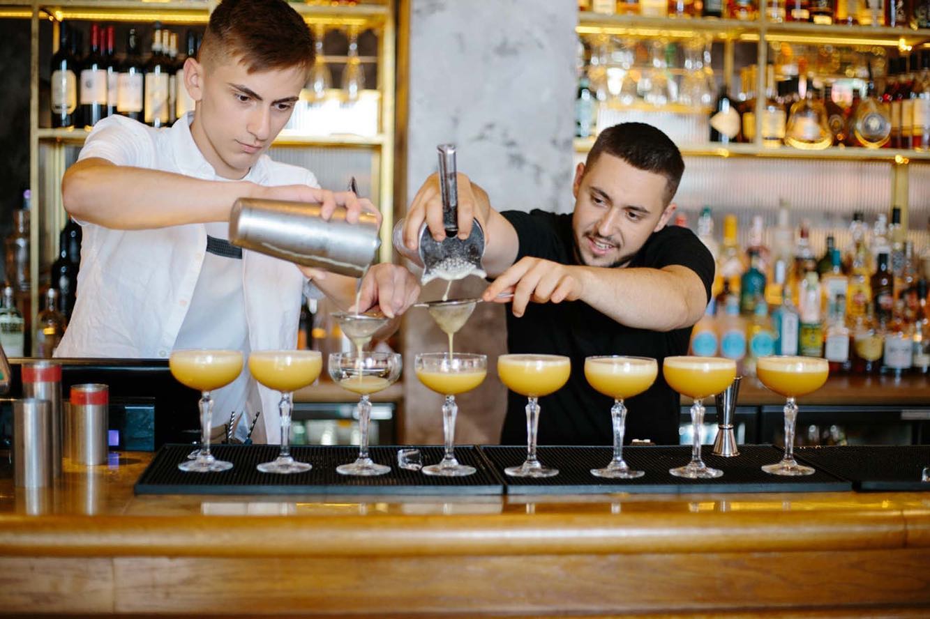 Bartenders making cocktails at Fleets, a bar in the St Pauls district of London