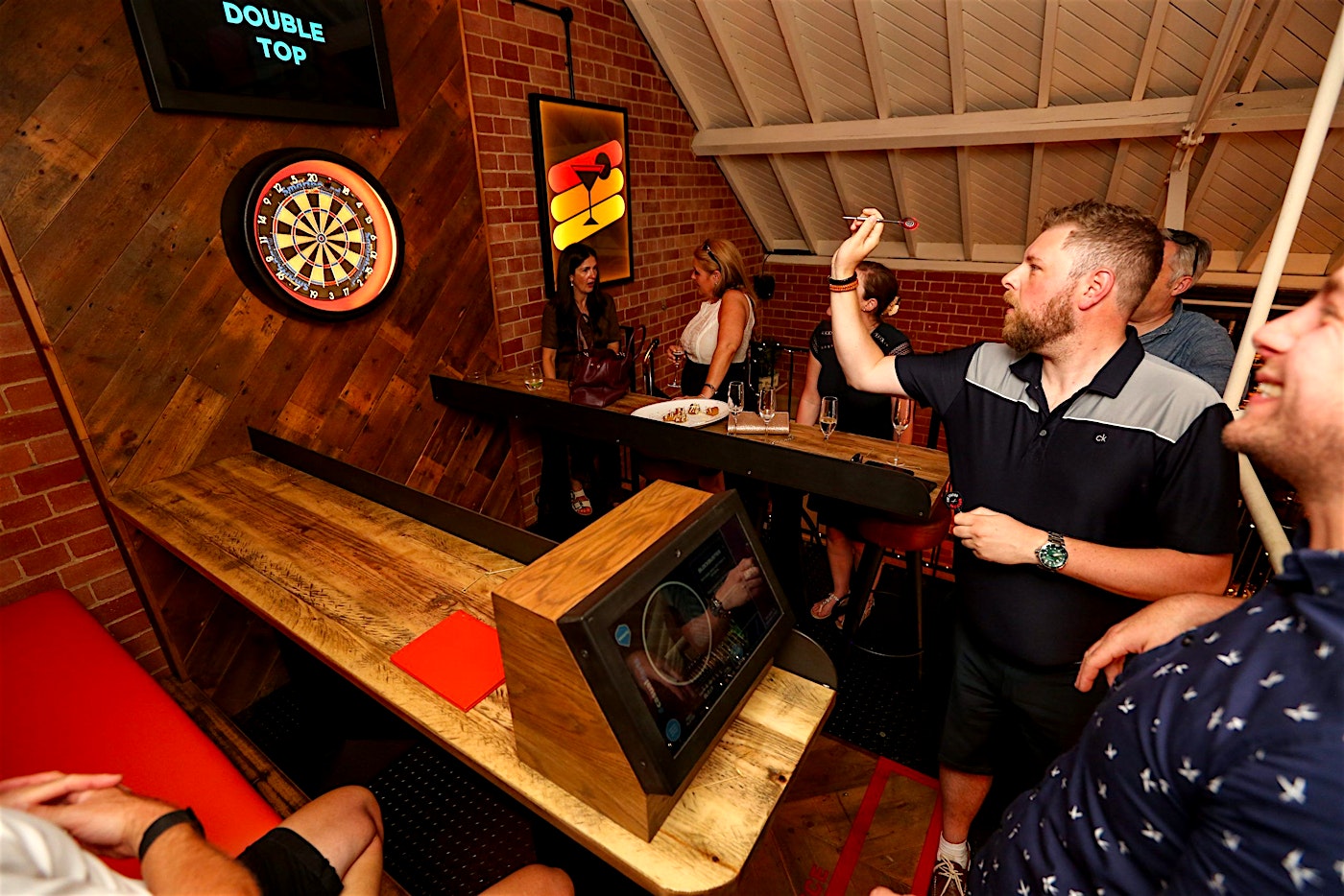 people playing darts at 180 darts club at austrin friars balls brothers city of london team-building activity venue