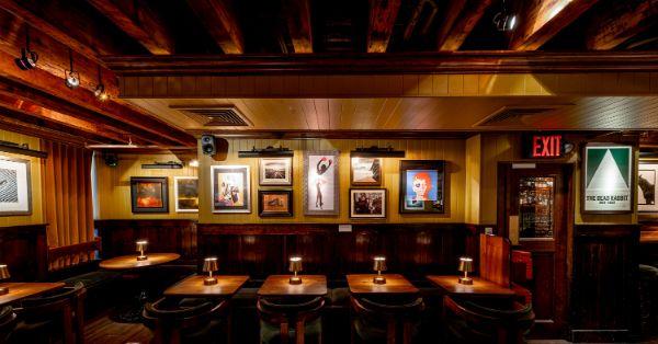 Seating area featuring a wide variety of artwork at The Dead Rabbit NYC, a bar for celebrating 21st birthdays in New York.