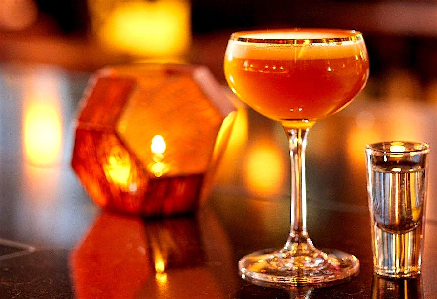 cocktail and candle at ga kingsx bar and restaurant in kings cross london