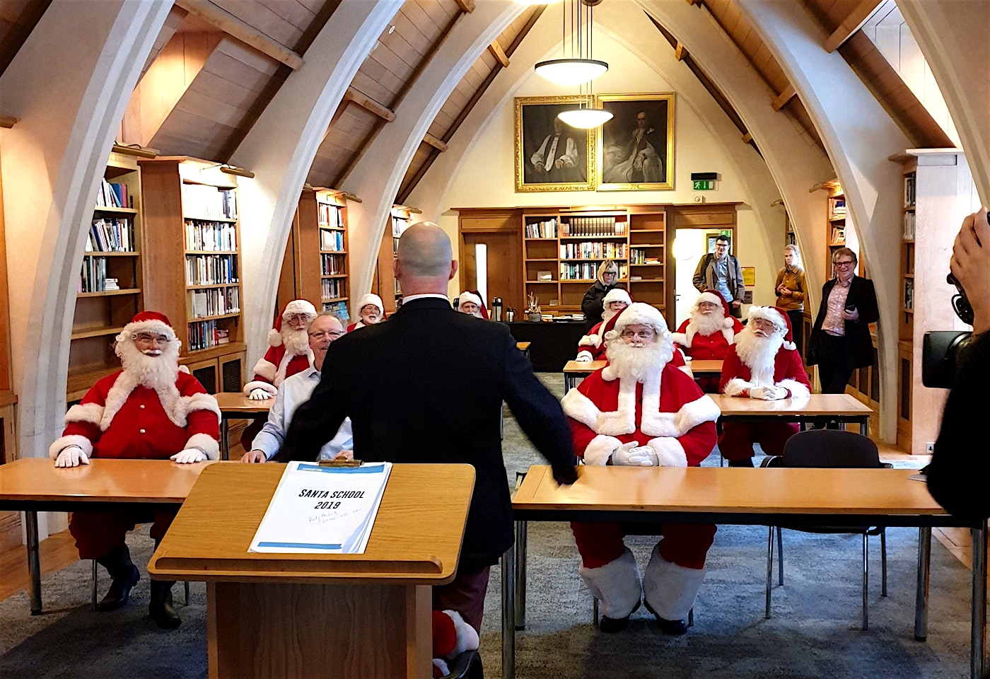a group of santas at the meeting room at the garry weston library at southwark cathedral