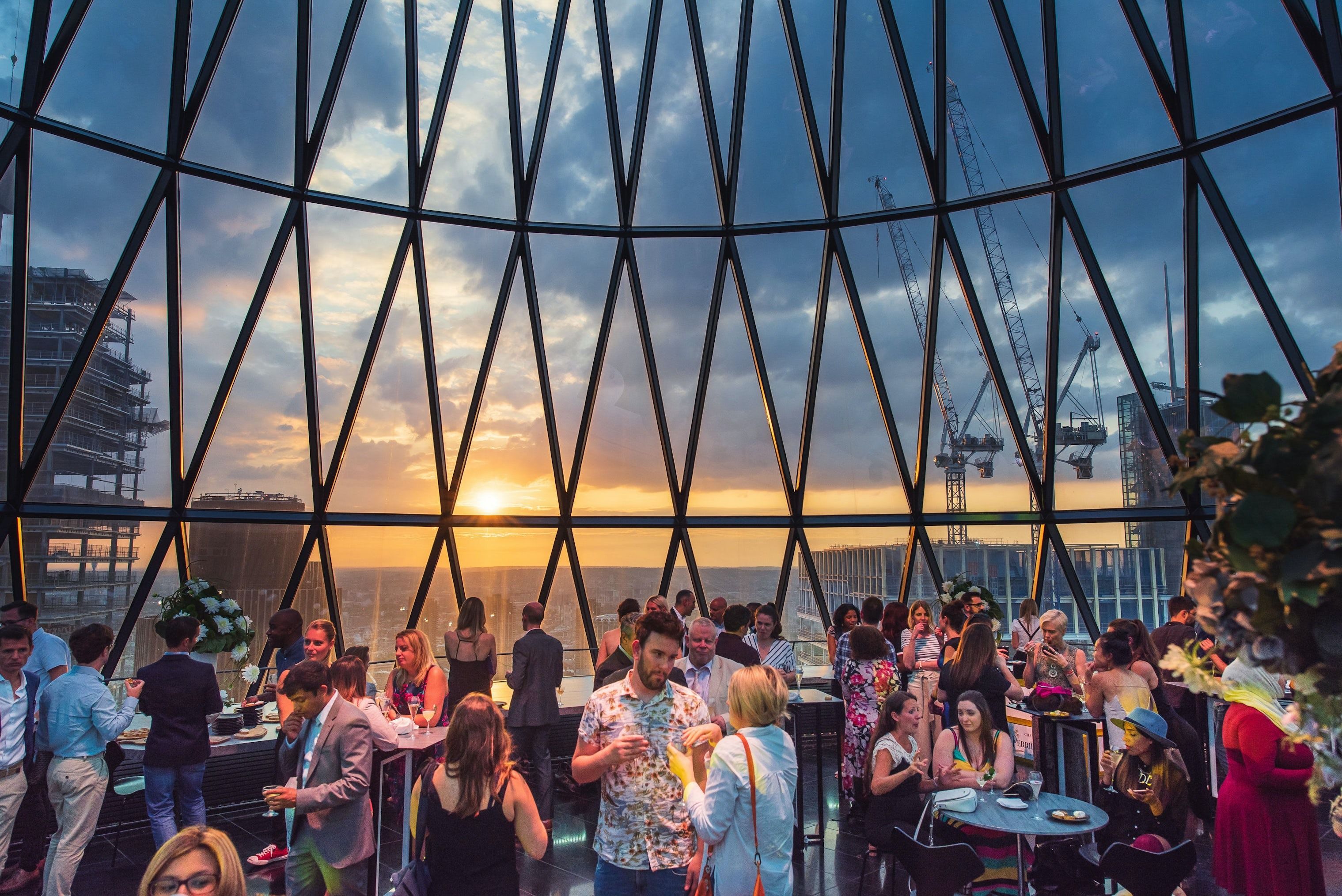 sunset and people at iris bar at searcys at the gherkin city of london rooftop bar