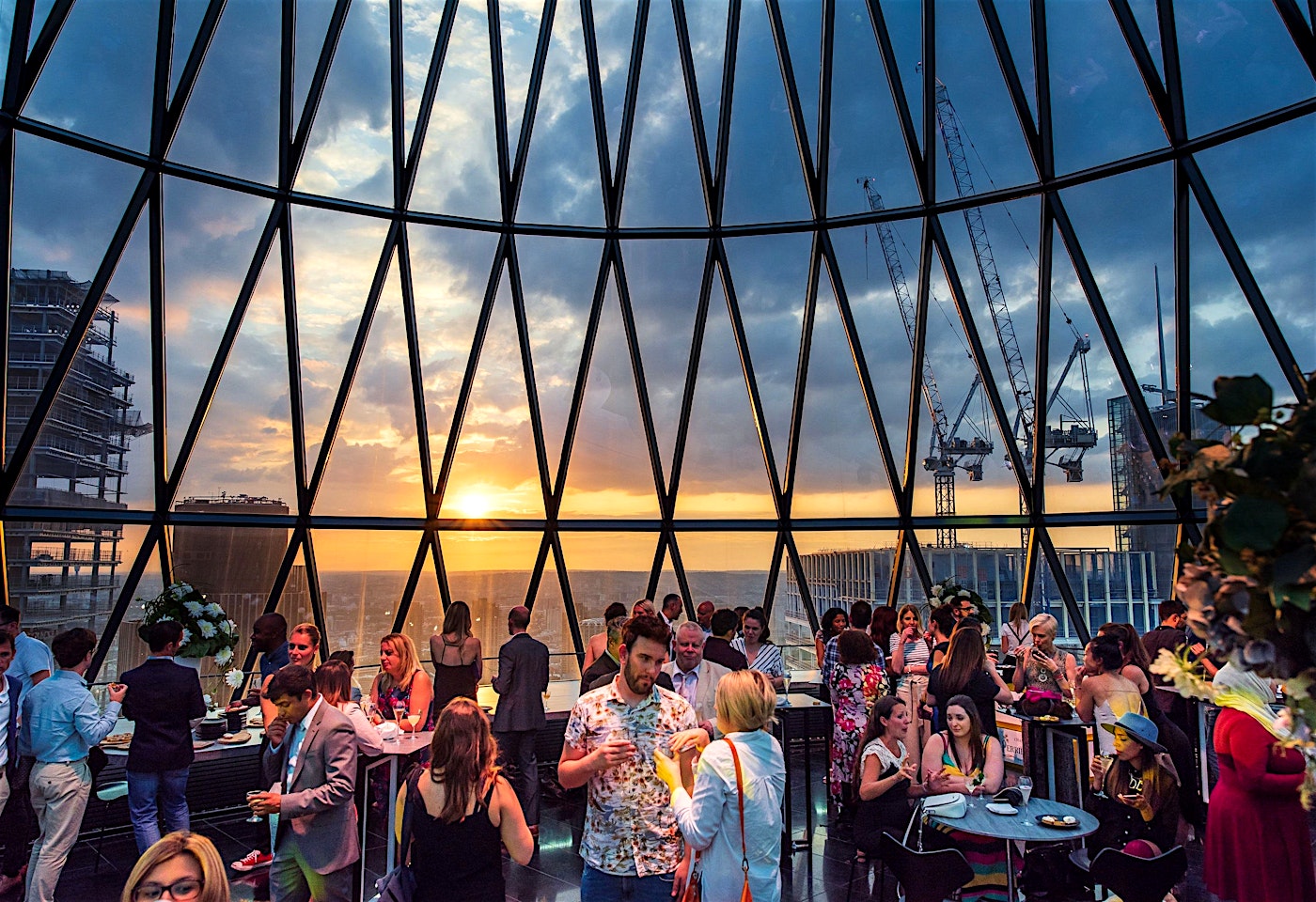 sunset and people at iris bar at searcys at the gherkin city of london rooftop bar