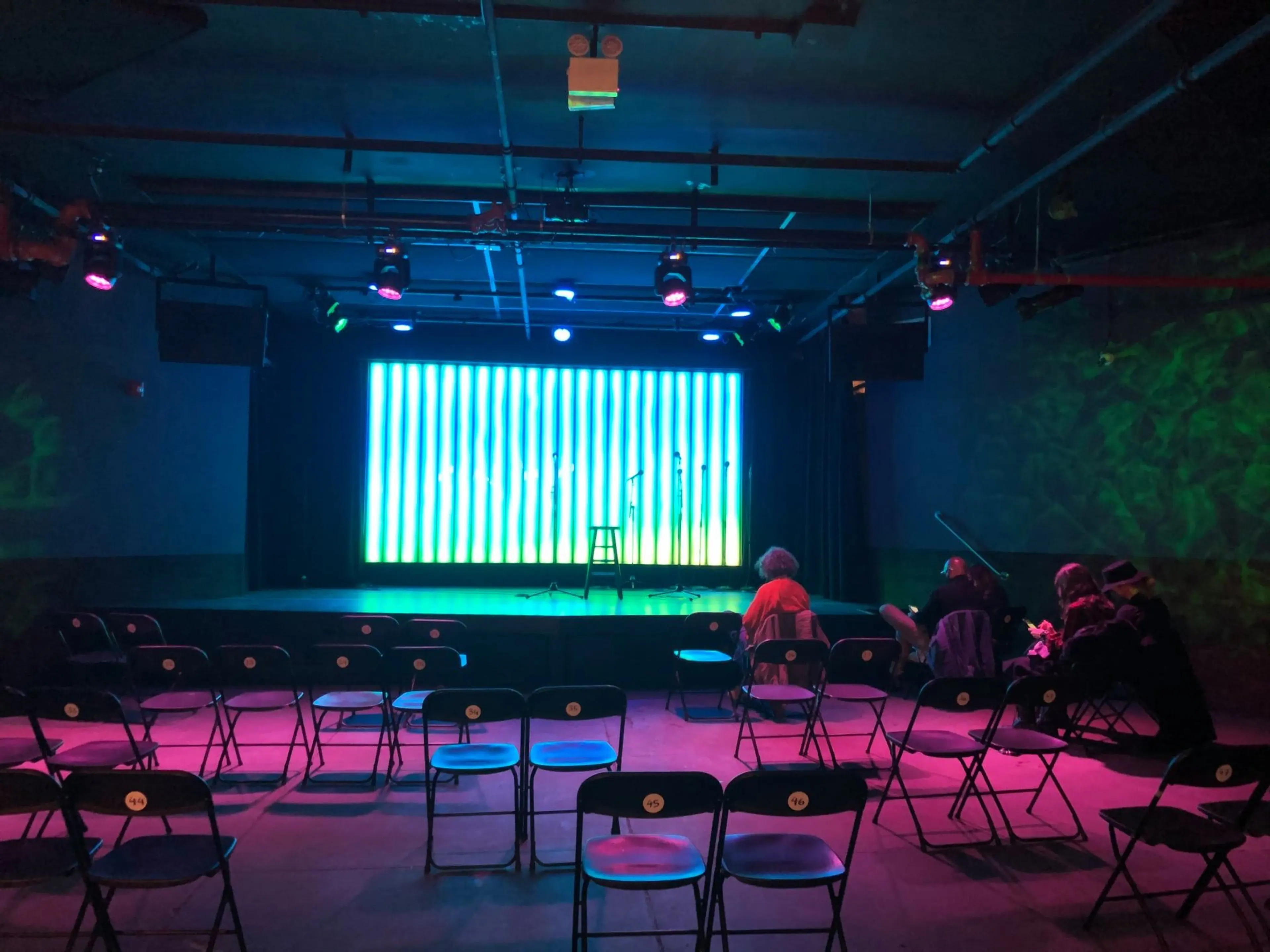 The stage at Littlefield, a comedy club in NYC, featuring a customizable LED board. 
