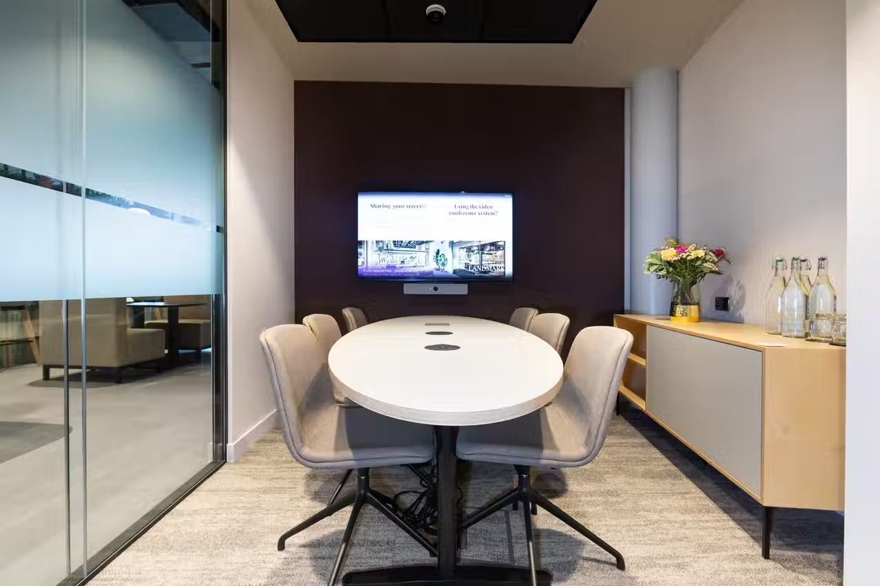 A mid-sized meeting room in London with TV screen
