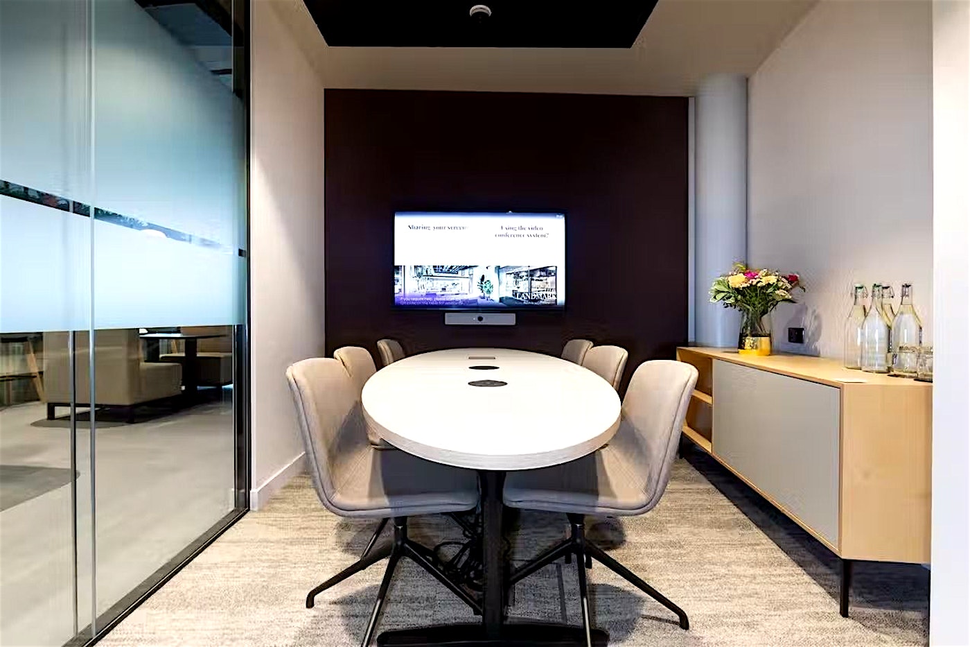 A mid-sized meeting room in London with TV screen