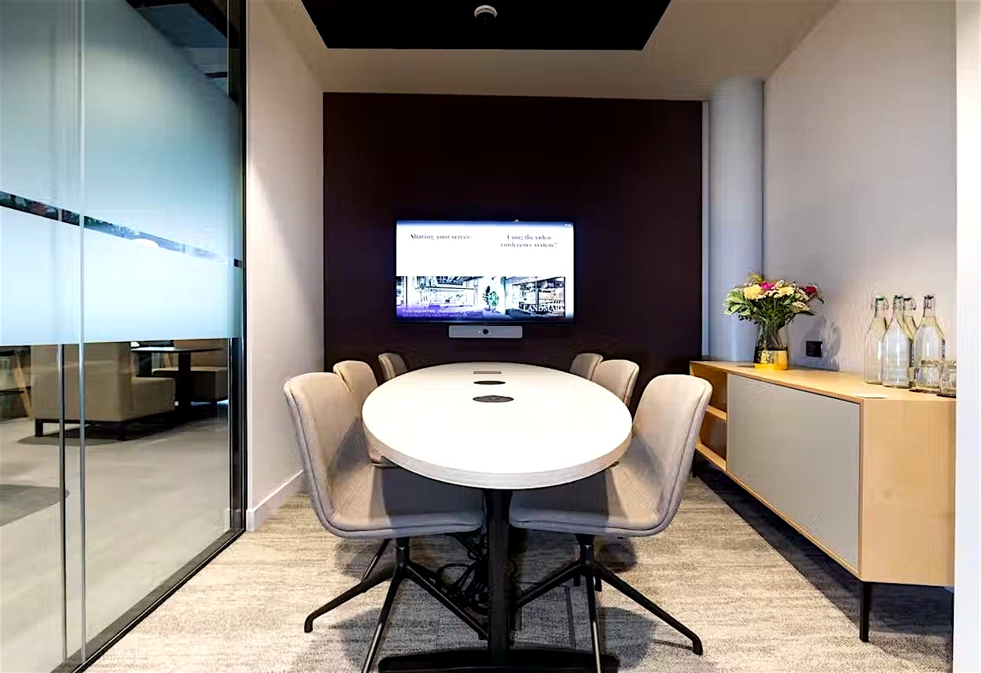 A mid-sized meeting room in London with TV screen