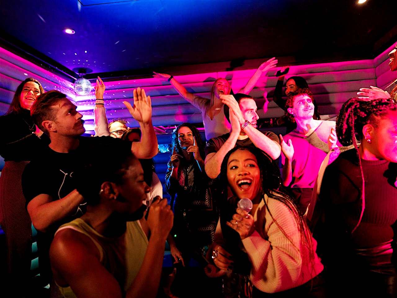  people in a karaoke room at lucky voice karaoke city of london team-building activity venue 