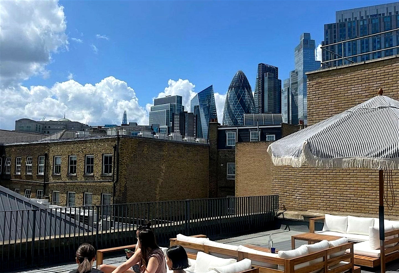 people on maene liverpool street rooftop bar london
