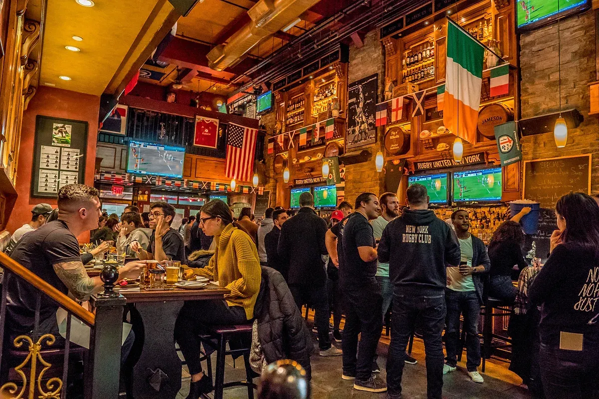 People watching sports at Pig n' Whistle, a sports bar in NYC. 