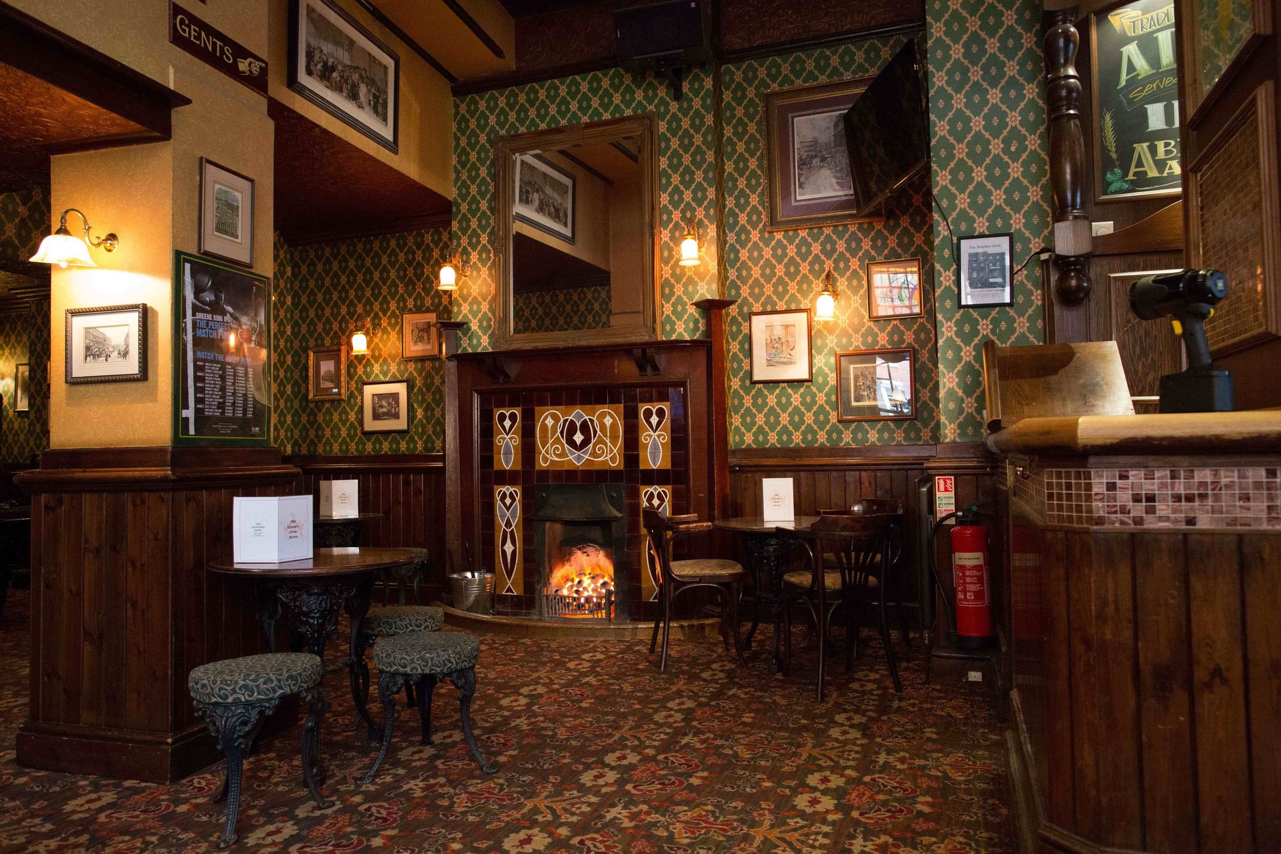 fireplace in the skinners arms pub in kings cross london