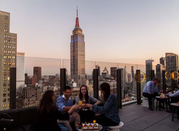 An outdoor terrace with views of the Empire State Building at The Skylark, a bar for celebrating 21st birthdays in New York.