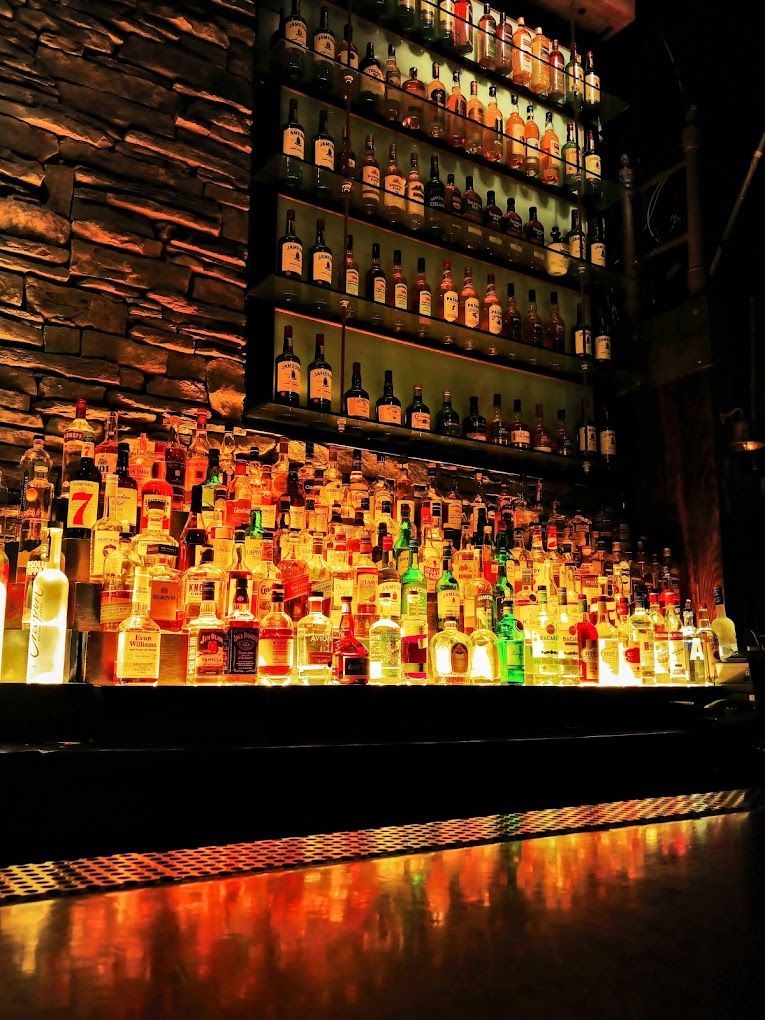 A wall of alcohol at Stout NYC at Penn Station, a sports in the city.