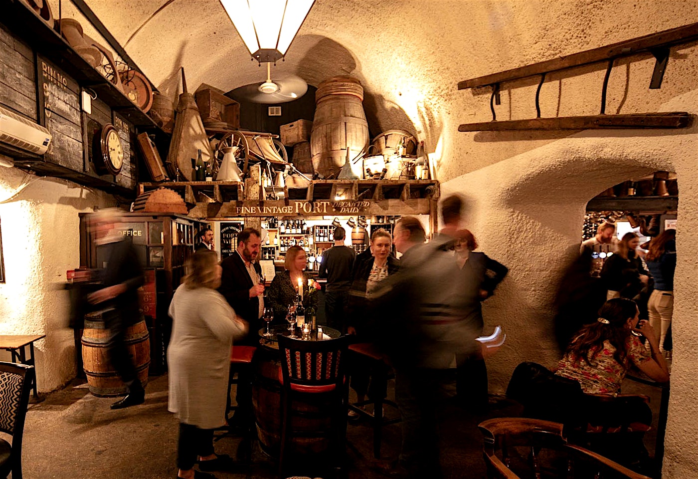 people under the arched ceilings of the London Bridge bar the Mug House wine bar